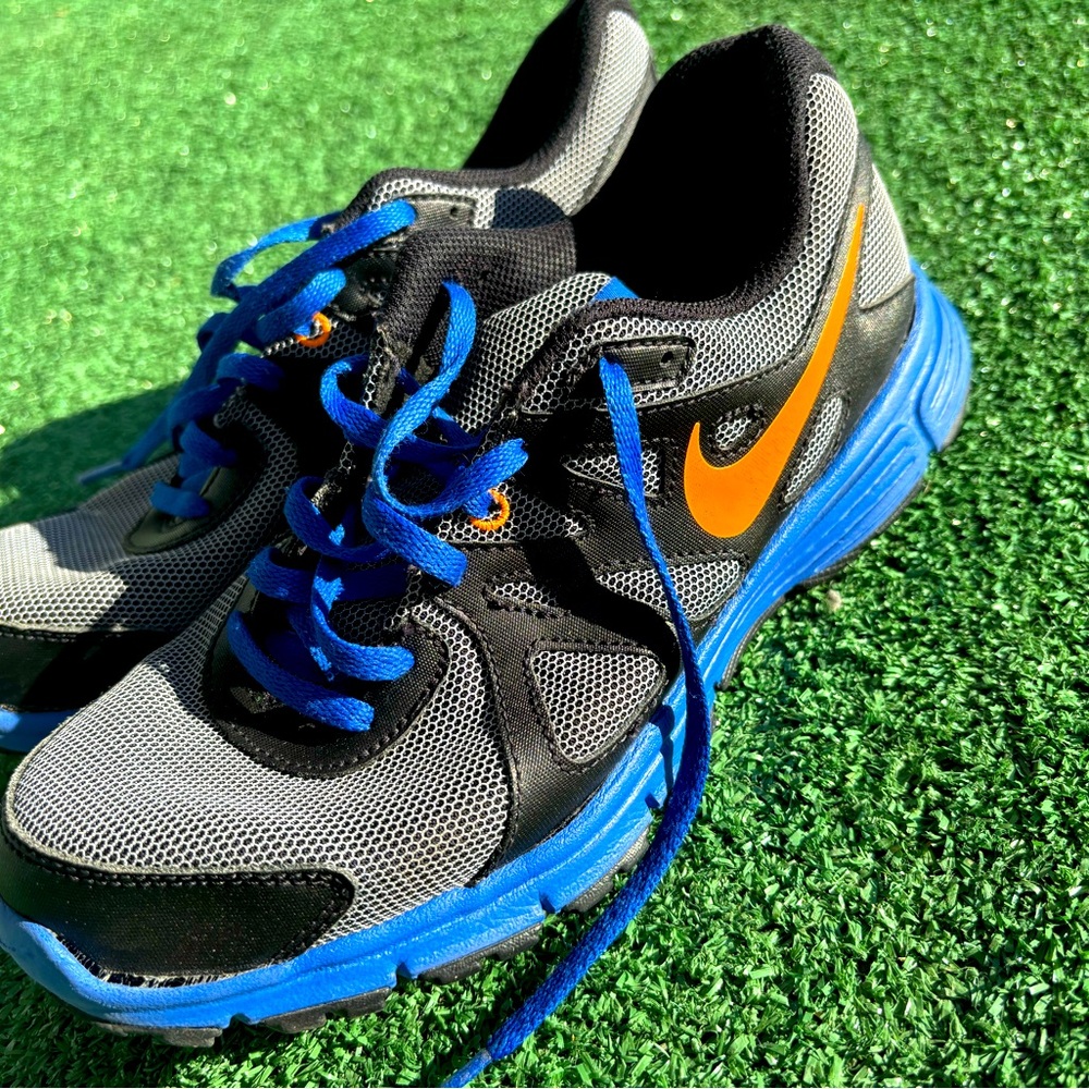 Blue, black, and orange training Nike shoes. 
There is some damage to one shoe.
